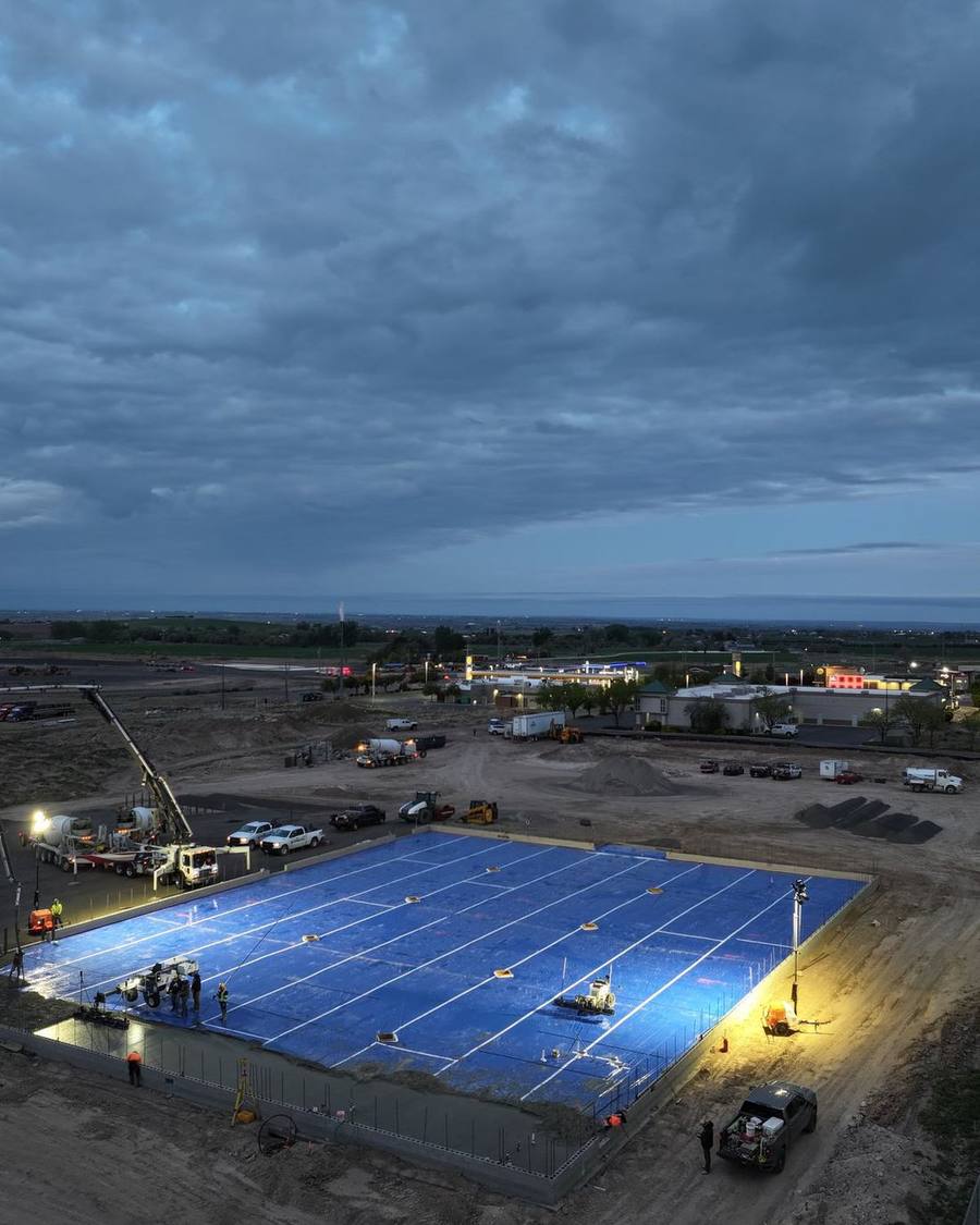 Large commercial concrete slab prepared for pour at dusk on a D&D Construction site